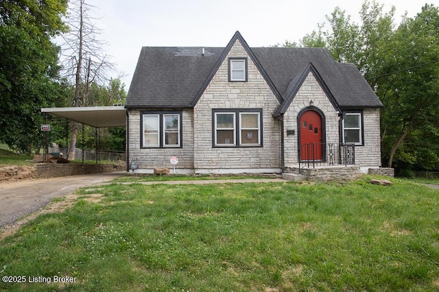 1436 Huntoon Ave, Louisville, KY 40215 - tudor house with stone siding, driveway, an attached carport, a front lawn, and a shingled roof