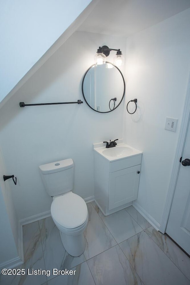 1436 Huntoon Ave, Louisville, KY 40215 - bathroom featuring marble look tiles, vanity, toilet, and baseboards