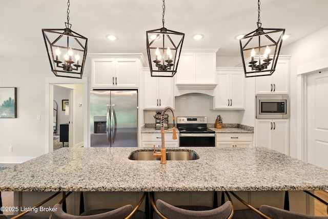 131 Gavin Dr, Shepherdsville, KY 40165 - kitchen with stainless steel appliances, a chandelier, a breakfast bar, an island with sink, and recessed lighting