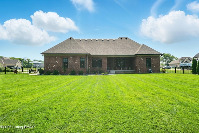 131 Gavin Dr, Shepherdsville, KY 40165 - back of property featuring a fenced backyard, roof with shingles, and brick siding