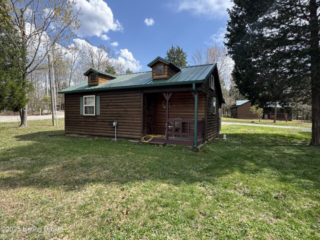 661 Blue Bird Rd, Falls Of Rough, KY 40119 - view of property exterior featuring faux log siding, a yard, and metal roof