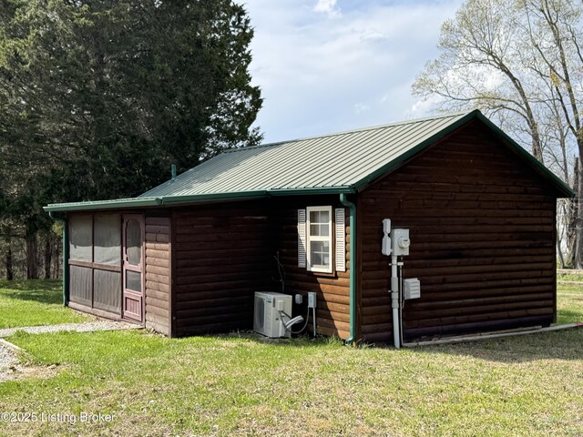 661 Blue Bird Rd, Falls Of Rough, KY 40119 - view of side of home with a cooling unit, a yard, faux log siding, and metal roof