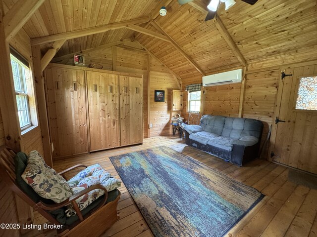 661 Blue Bird Rd, Falls Of Rough, KY 40119 - living area featuring an AC wall unit, wooden walls, healthy amount of natural light, wood ceiling, and wood-type flooring