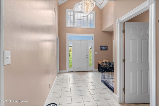 177 Airport Rd, Leitchfield, KY 42754 - entryway with baseboards, a towering ceiling, a chandelier, and light tile patterned flooring
