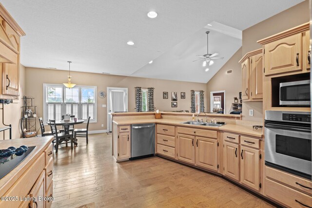 177 Airport Rd, Leitchfield, KY 42754 - kitchen featuring stainless steel appliances, light brown cabinetry, a sink, light countertops, and a peninsula