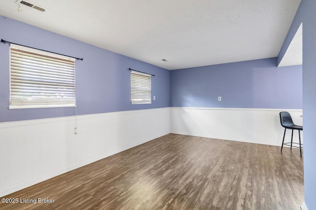 6600 Musket Dr, Louisville, KY 40228 - empty room featuring wood finished floors, healthy amount of natural light, and wainscoting