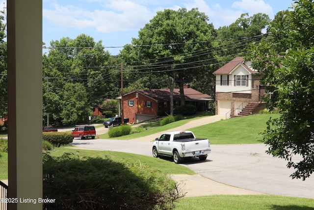 502 Hill Ridge Rd, Louisville, KY 40214 - view of green lawn featuring a garage and driveway
