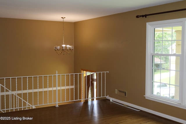 502 Hill Ridge Rd, Louisville, KY 40214 - unfurnished room featuring a chandelier and dark wood-style flooring