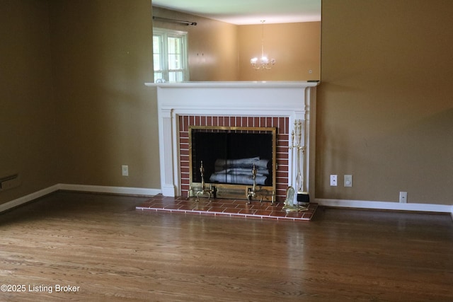 502 Hill Ridge Rd, Louisville, KY 40214 - unfurnished living room with wood finished floors, a chandelier, and a brick fireplace