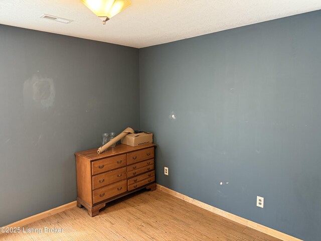 775 Constantine Vertrees Rd, Garfield, KY 40140 - bedroom with light wood finished floors, baseboards, and a textured ceiling