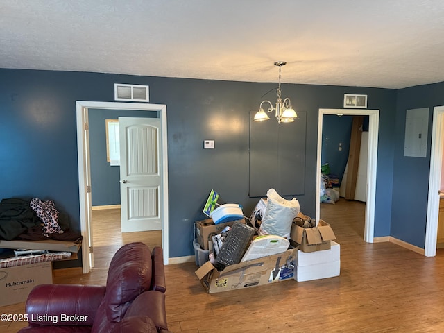 775 Constantine Vertrees Rd, Garfield, KY 40140 - living area with baseboards, a chandelier, and wood finished floors