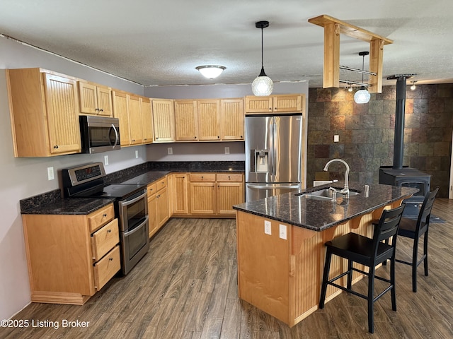 775 Constantine Vertrees Rd, Garfield, KY 40140 - kitchen with stainless steel appliances, a sink, dark wood-style floors, a breakfast bar area, and light brown cabinetry