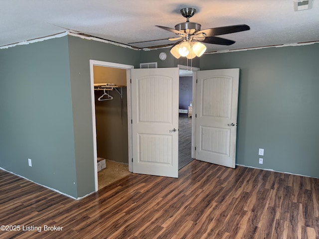 775 Constantine Vertrees Rd, Garfield, KY 40140 - unfurnished bedroom featuring wood finished floors, a spacious closet, ceiling fan, a closet, and a textured ceiling