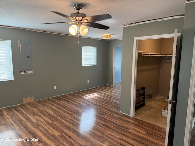 775 Constantine Vertrees Rd, Garfield, KY 40140 - unfurnished bedroom with electric panel, dark wood-style floors, a walk in closet, a textured ceiling, and a closet
