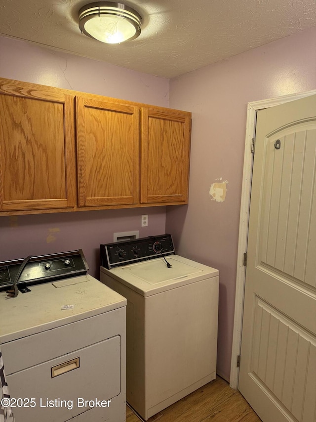 775 Constantine Vertrees Rd, Garfield, KY 40140 - washroom featuring cabinet space, washing machine and dryer, and light wood-style floors