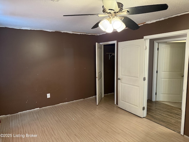 775 Constantine Vertrees Rd, Garfield, KY 40140 - unfurnished bedroom with light wood-style floors, ceiling fan, a closet, and baseboards