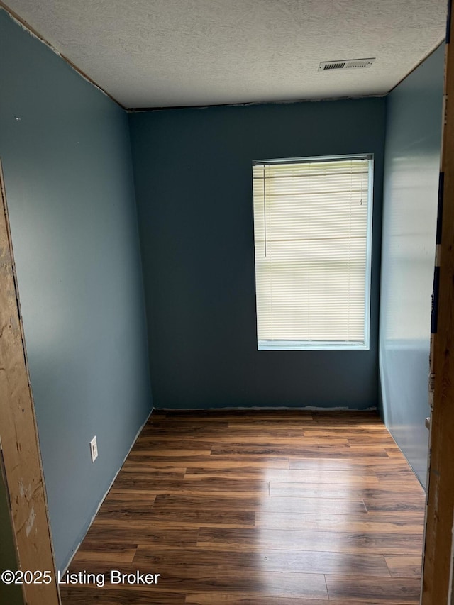 775 Constantine Vertrees Rd, Garfield, KY 40140 - spare room featuring wood finished floors and a textured ceiling