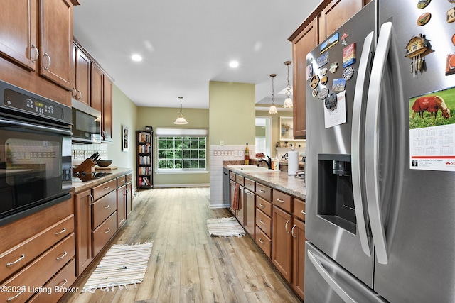 4107 Dolphin Rd, Louisville, KY 40220 - kitchen with black appliances, light wood-type flooring, a sink, brown cabinets, and recessed lighting