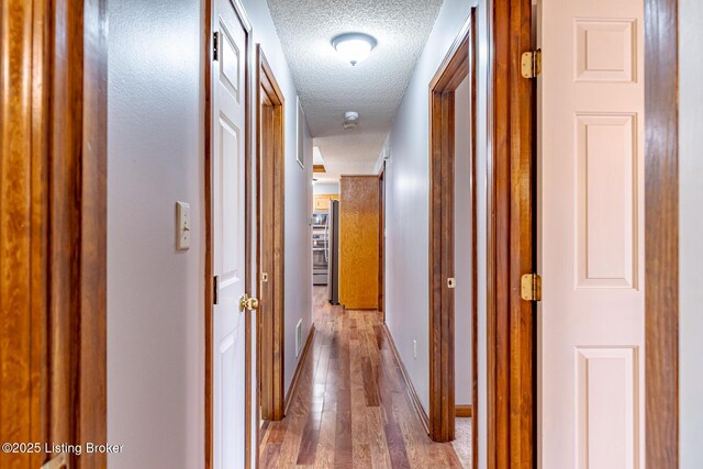 1117 Breezy Way, Bardstown, KY 40004 - hallway featuring a textured ceiling and hardwood / wood-style floors