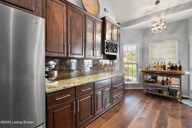 1406 Rutland Club Ct, Louisville, KY 40245 - kitchen with freestanding refrigerator, dark wood-style floors, decorative backsplash, light stone counters, and glass insert cabinets