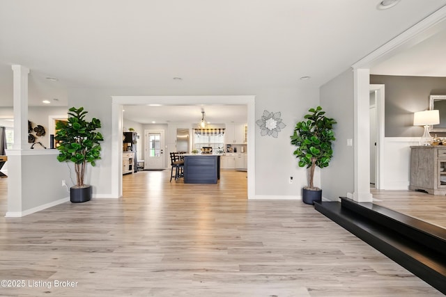 1717 Stricker Rd, Memphis, IN 47143 - living area featuring light wood-style floors, recessed lighting, baseboards, and ornate columns