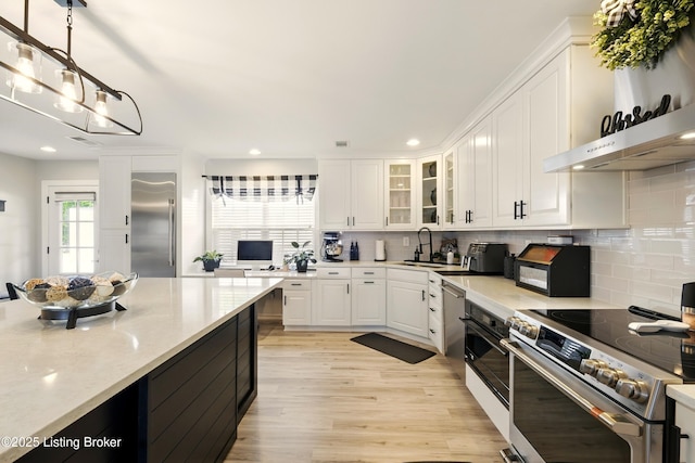 1717 Stricker Rd, Memphis, IN 47143 - kitchen featuring appliances with stainless steel finishes, light wood-style flooring, white cabinetry, decorative backsplash, and recessed lighting