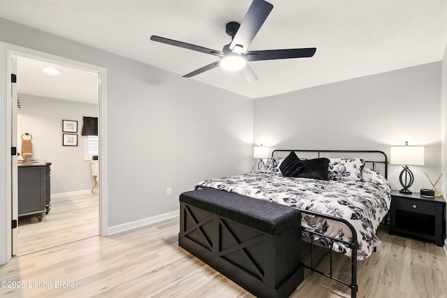 1717 Stricker Rd, Memphis, IN 47143 - bedroom with light wood-style flooring, baseboards, and a ceiling fan