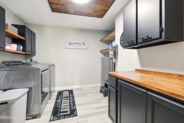 1717 Stricker Rd, Memphis, IN 47143 - laundry area with washing machine and clothes dryer, cabinet space, light wood finished floors, baseboards, and water heater
