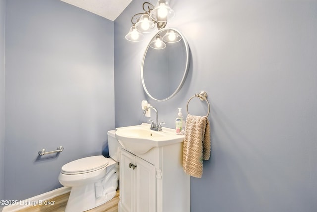 1717 Stricker Rd, Memphis, IN 47143 - half bath featuring vanity, baseboards, wood finished floors, and toilet