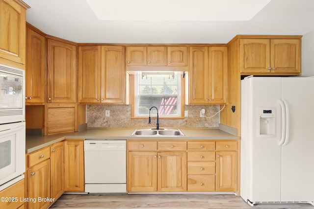 1717 Stricker Rd, Memphis, IN 47143 - kitchen with white appliances, a sink, light wood-style floors, and backsplash