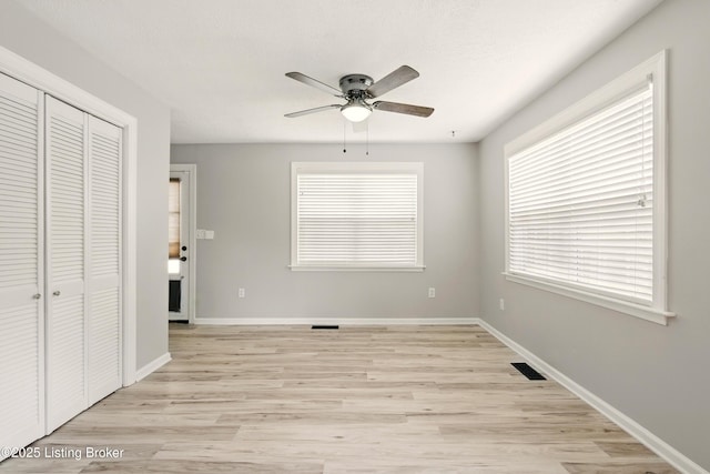 1717 Stricker Rd, Memphis, IN 47143 - unfurnished bedroom with light wood-type flooring, a closet, multiple windows, and baseboards