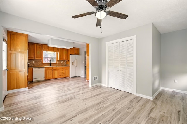 1717 Stricker Rd, Memphis, IN 47143 - kitchen featuring white appliances, a sink, light wood-style floors, and baseboards