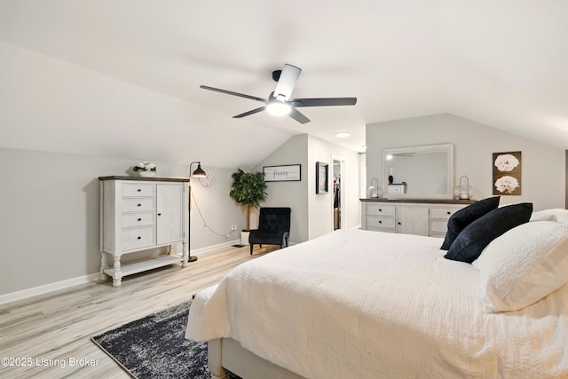 1717 Stricker Rd, Memphis, IN 47143 - bedroom with light wood-style flooring, lofted ceiling, baseboards, a ceiling fan, and a spacious closet