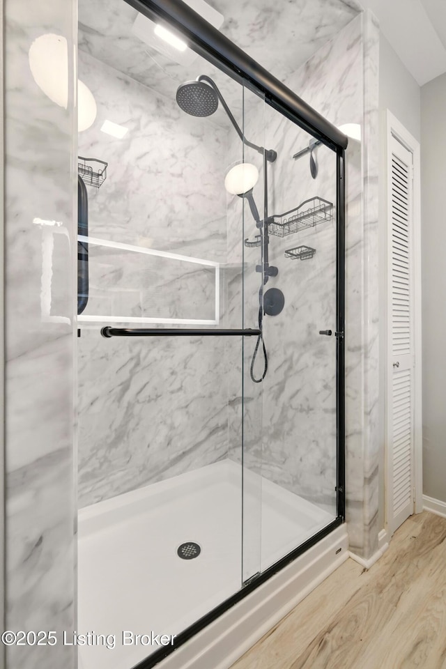 1717 Stricker Rd, Memphis, IN 47143 - bathroom with a marble finish shower, wood finished floors, a closet, and baseboards