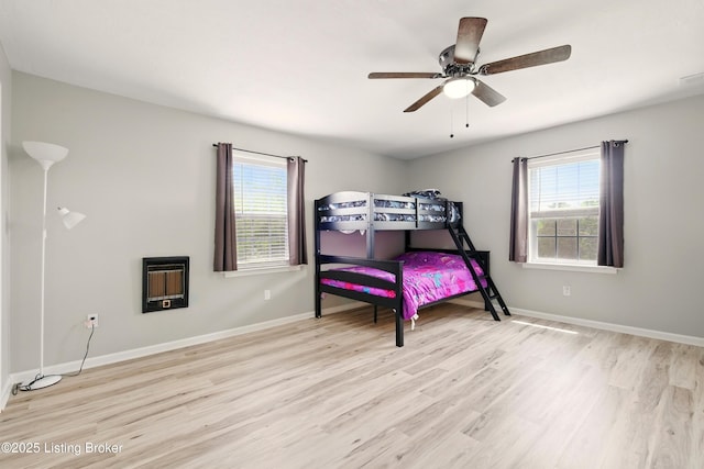 1717 Stricker Rd, Memphis, IN 47143 - bedroom with heating unit, multiple windows, and wood finished floors