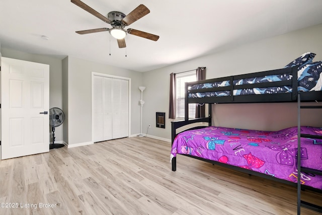 1717 Stricker Rd, Memphis, IN 47143 - bedroom with wood finished floors, baseboards, a closet, and a ceiling fan