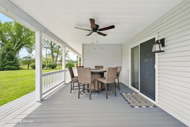 1717 Stricker Rd, Memphis, IN 47143 - wooden deck featuring outdoor dining area, a lawn, and ceiling fan