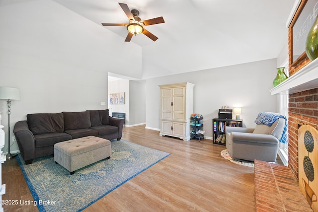 14312 Micawber Way, Louisville, KY 40245 - living area featuring ceiling fan, light wood-style flooring, high vaulted ceiling, a fireplace, and baseboards
