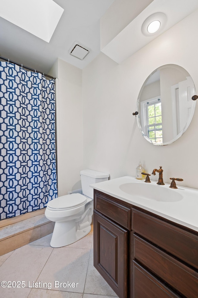 14312 Micawber Way, Louisville, KY 40245 - bathroom with vanity, tile patterned floors, toilet, and a skylight