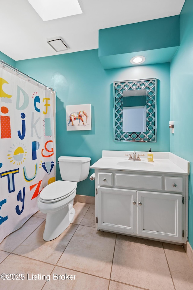 14312 Micawber Way, Louisville, KY 40245 - full bath with tile patterned flooring, toilet, vanity, a skylight, and baseboards