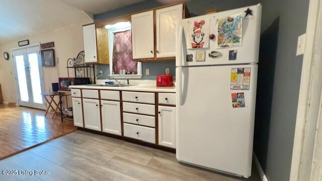 187 Glenn Rd, Leitchfield, KY 42754 - kitchen featuring freestanding refrigerator, light wood-type flooring, a sink, and light countertops
