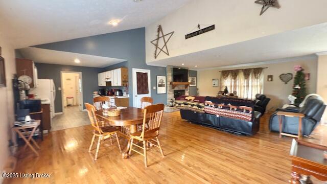 187 Glenn Rd, Leitchfield, KY 42754 - dining room featuring high vaulted ceiling, light wood finished floors, and a fireplace