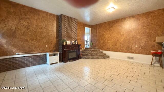 187 Glenn Rd, Leitchfield, KY 42754 - unfurnished living room with tile patterned floors and a fireplace