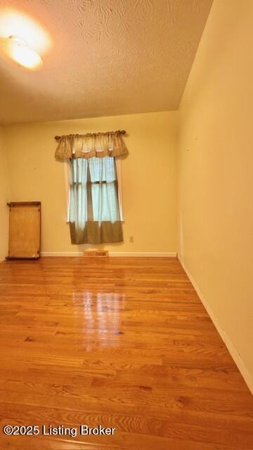 187 Glenn Rd, Leitchfield, KY 42754 - unfurnished room featuring wood finished floors, baseboards, and a textured ceiling