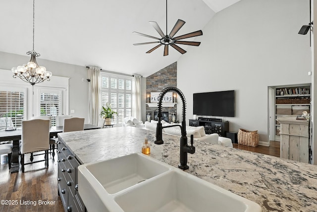 13127 Wilhoyte Ct Unit 13127, Prospect, KY 40059 - kitchen featuring open floor plan, a ceiling fan, dark wood-type flooring, high vaulted ceiling, and light stone countertops