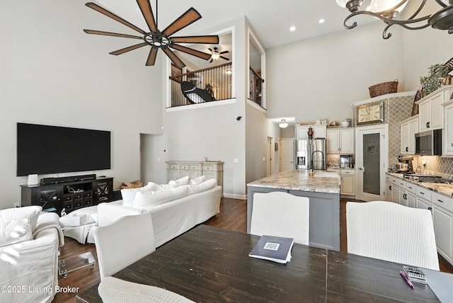 13127 Wilhoyte Ct Unit 13127, Prospect, KY 40059 - dining room with a towering ceiling, ceiling fan, dark wood-type flooring, a chandelier, and recessed lighting