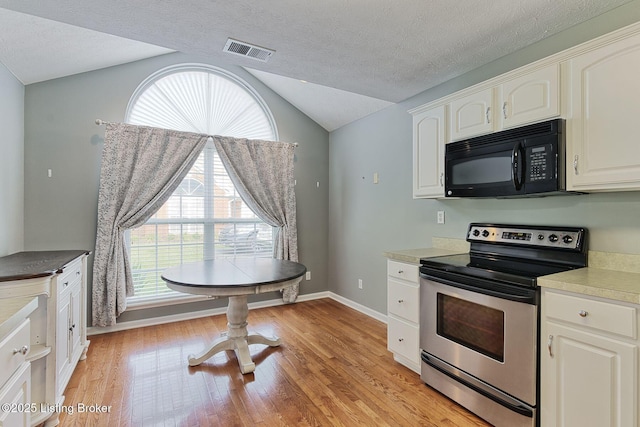 10540 Monticello Forest Cir, Louisville, KY 40299 - kitchen featuring stainless steel electric range, black microwave, lofted ceiling, light wood-style flooring, and white cabinets