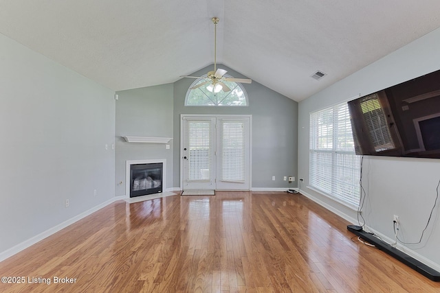 10540 Monticello Forest Cir, Louisville, KY 40299 - unfurnished living room with a ceiling fan, wood finished floors, vaulted ceiling, plenty of natural light, and a glass covered fireplace