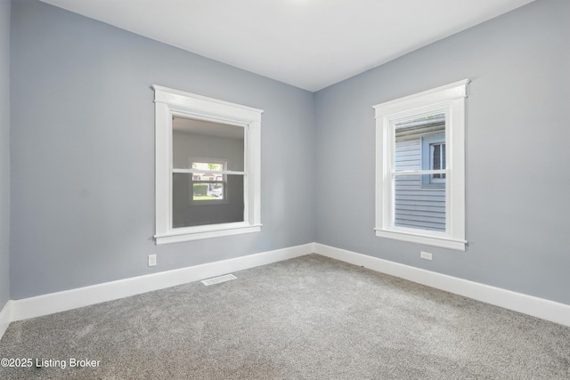 220 N 39th St, Louisville, KY 40212 - carpeted empty room with baseboards