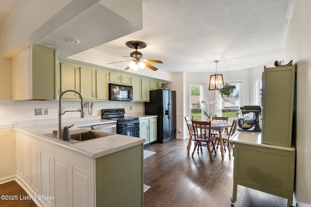 6800 Beard Ct, Louisville, KY 40228 - kitchen with black appliances, green cabinets, light countertops, ceiling fan, and dark wood-type flooring